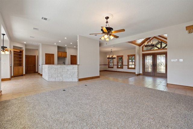 unfurnished living room featuring light carpet, lofted ceiling with beams, and ceiling fan with notable chandelier