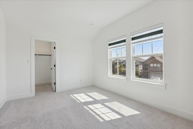 1325 Kneehigh Dr, Georgetown, TX 78633 - unfurnished bedroom featuring carpet flooring, vaulted ceiling, and a walk in closet