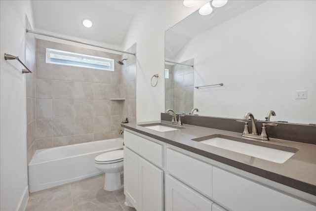 full bathroom featuring tile patterned flooring, vanity, toilet, and tiled shower / bath combo