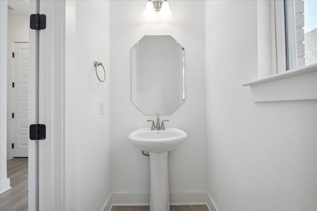 bathroom with wood-type flooring and sink