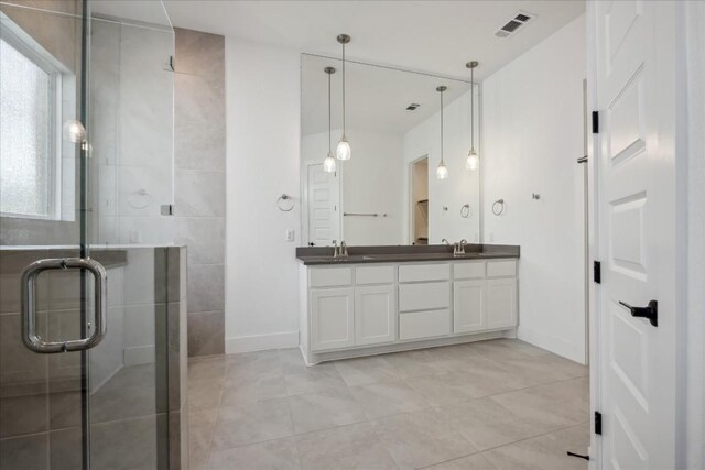 bathroom featuring tile patterned floors, vanity, and walk in shower