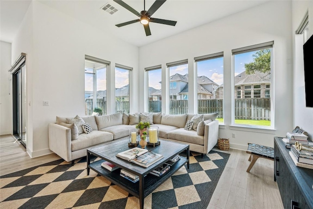 1325 Kneehigh Dr, Georgetown, TX 78633 - living room with healthy amount of natural light, ceiling fan, and light wood-style flooring