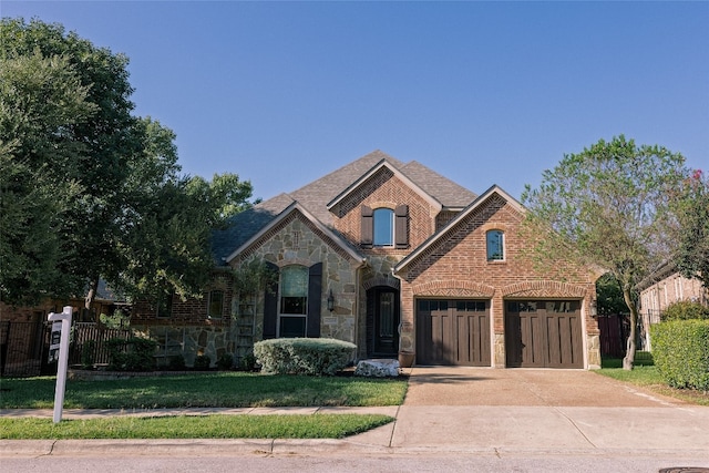 view of front of house with a front yard and a garage