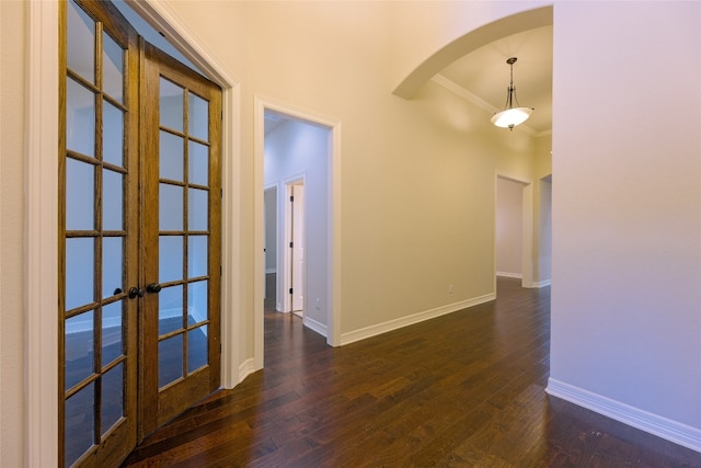 interior space with ornamental molding, french doors, and dark hardwood / wood-style floors