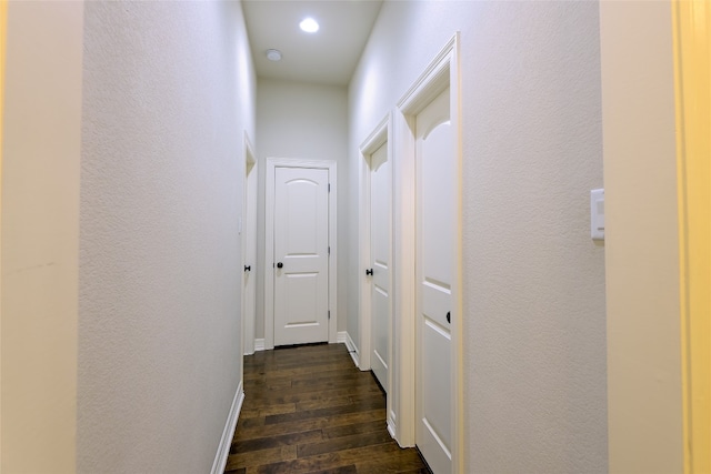 corridor with dark hardwood / wood-style flooring