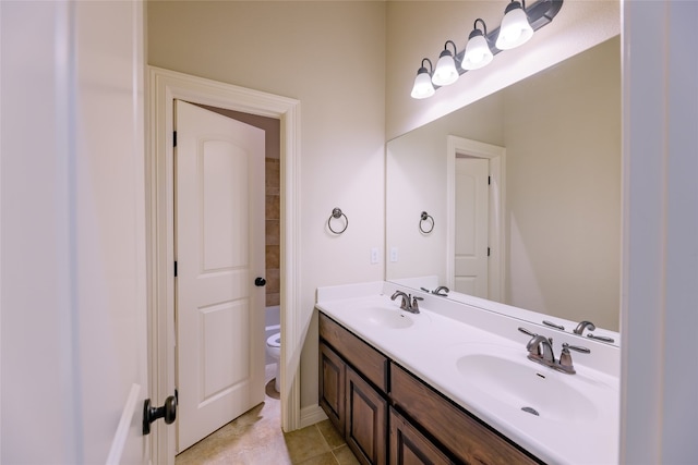 bathroom with vanity, toilet, and tile patterned flooring