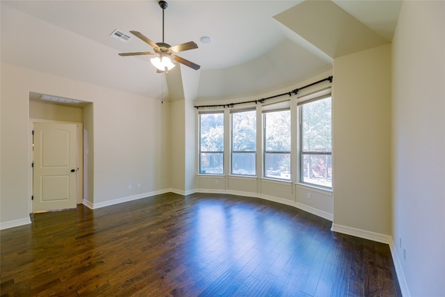 unfurnished room with a wealth of natural light, lofted ceiling, dark hardwood / wood-style floors, and ceiling fan