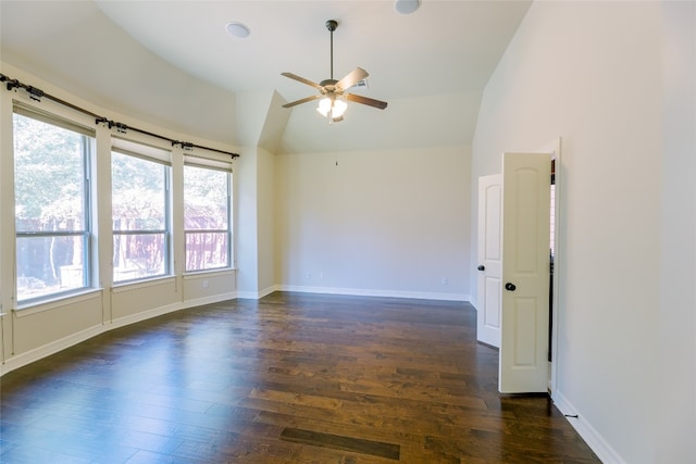 spare room with ceiling fan, vaulted ceiling, dark hardwood / wood-style flooring, and plenty of natural light