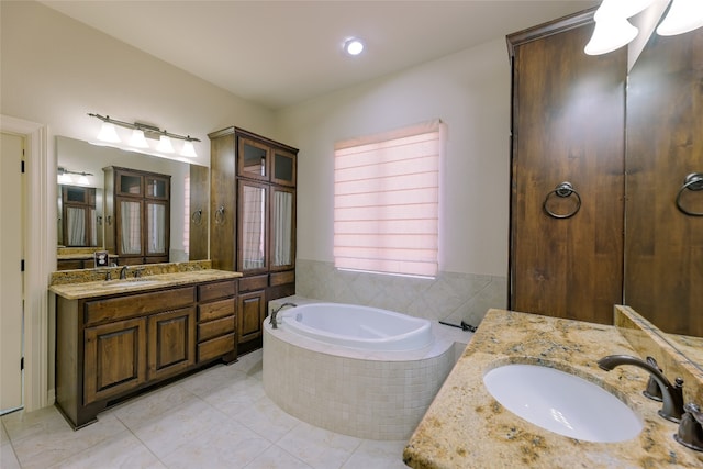 bathroom featuring vanity, a relaxing tiled tub, and tile patterned floors