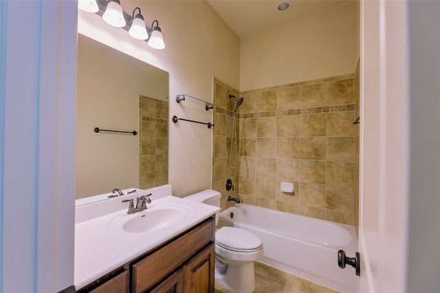 full bathroom featuring toilet, tiled shower / bath, vanity, and tile patterned floors