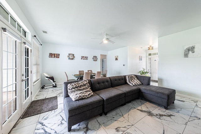 living room featuring french doors and ceiling fan