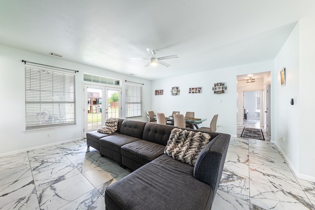 living room featuring french doors and ceiling fan