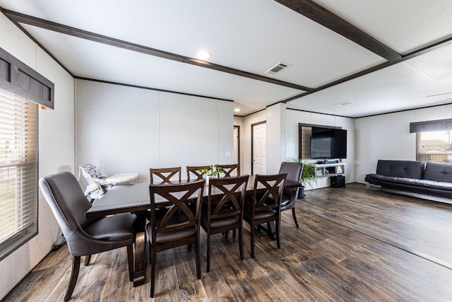 dining area with beamed ceiling and dark hardwood / wood-style floors