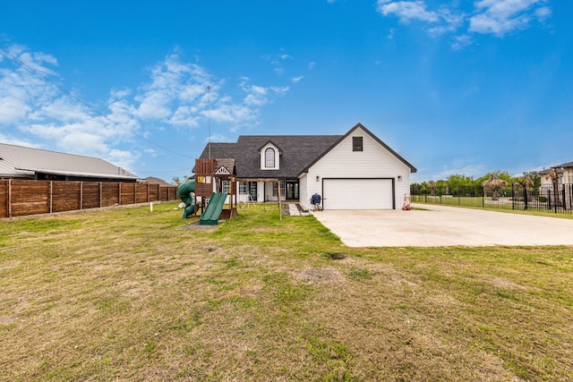 view of front of house with a playground, a front lawn, and a garage