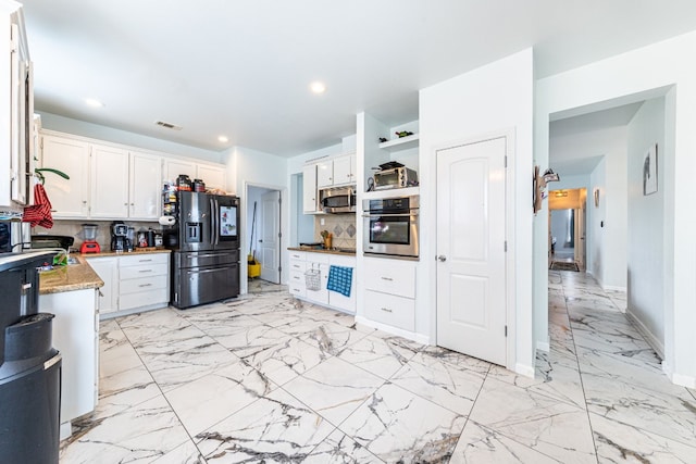 kitchen with white cabinetry, decorative backsplash, stainless steel appliances, and light stone counters