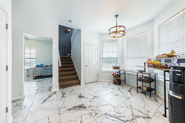 foyer entrance featuring an inviting chandelier