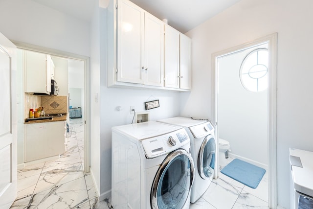 laundry room featuring cabinets and washing machine and clothes dryer