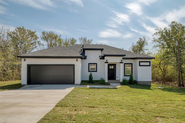 prairie-style home with a garage and a front yard