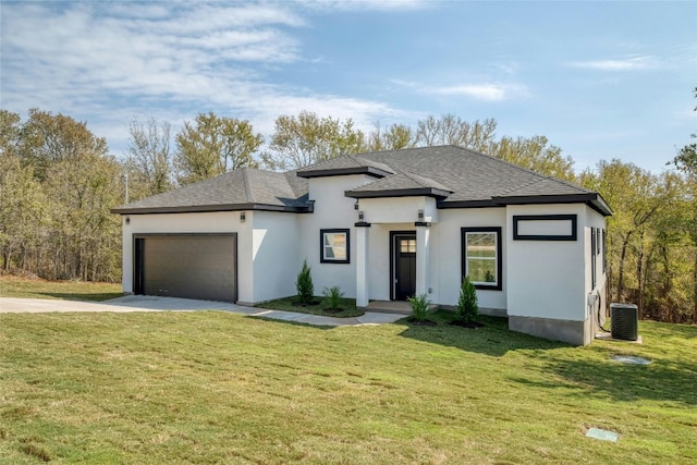 prairie-style house featuring a garage and a front yard