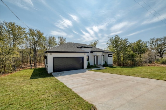 view of front of property with a front yard and a garage