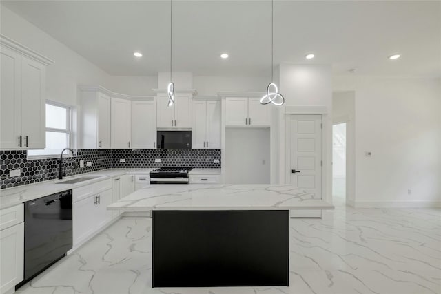 kitchen featuring hanging light fixtures, sink, stainless steel appliances, and a center island