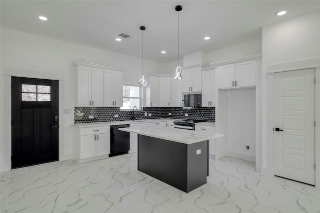 kitchen with white cabinetry, appliances with stainless steel finishes, and a kitchen island