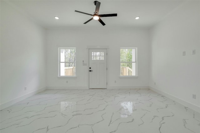 interior space featuring ceiling fan and a healthy amount of sunlight