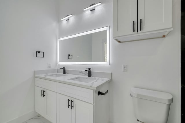 bathroom featuring toilet and vanity