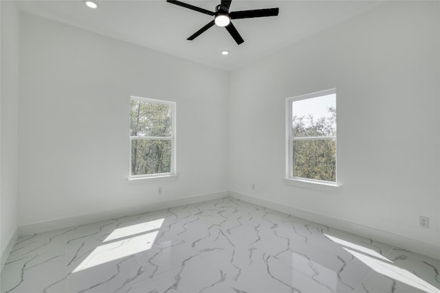 unfurnished room with ceiling fan and plenty of natural light