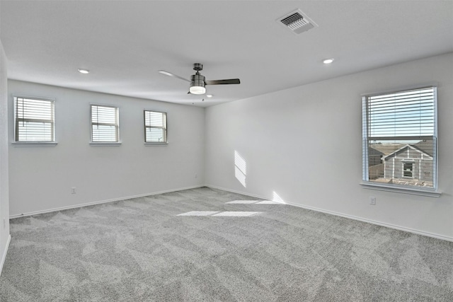 unfurnished room with light carpet and ceiling fan