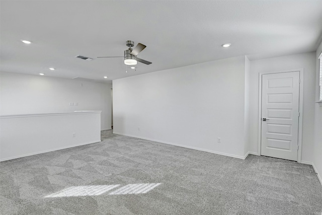 spare room featuring ceiling fan and light colored carpet