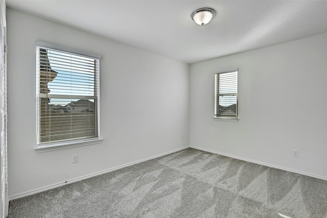 spare room with carpet and a healthy amount of sunlight