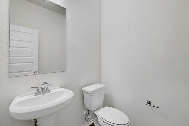 bathroom featuring toilet and sink