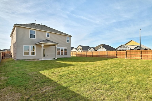 back of property featuring a lawn, central air condition unit, and a patio