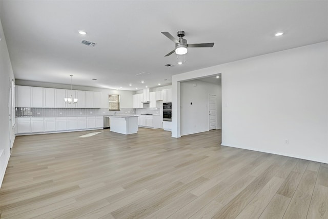 unfurnished living room with ceiling fan and light wood-type flooring