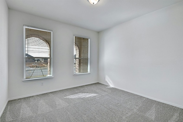 unfurnished room featuring carpet flooring