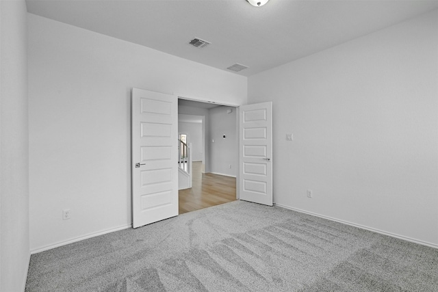 unfurnished bedroom featuring light colored carpet