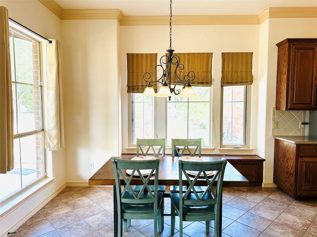 tiled dining space featuring a wealth of natural light, crown molding, and a notable chandelier