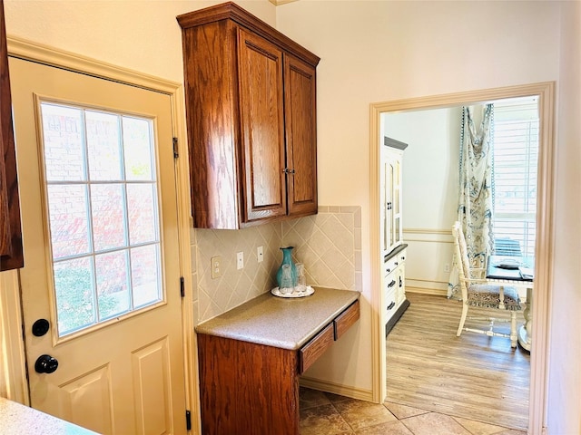 kitchen with light tile patterned floors and tasteful backsplash