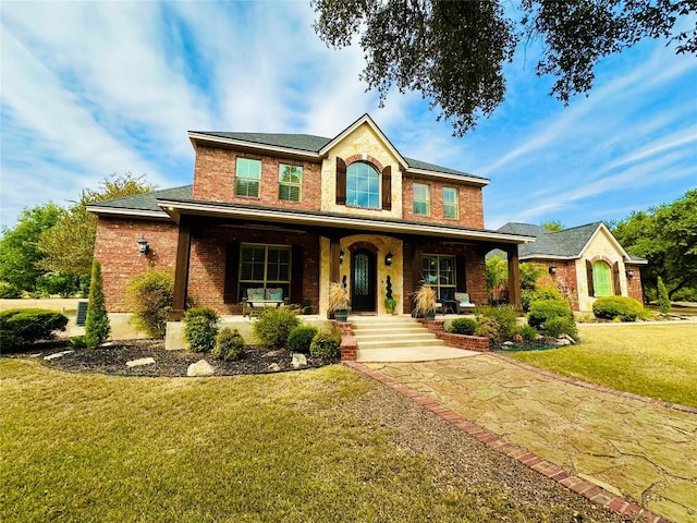 300 Copper Ln, Leander, TX 78641 - traditional-style home featuring brick siding, covered porch, and a front yard