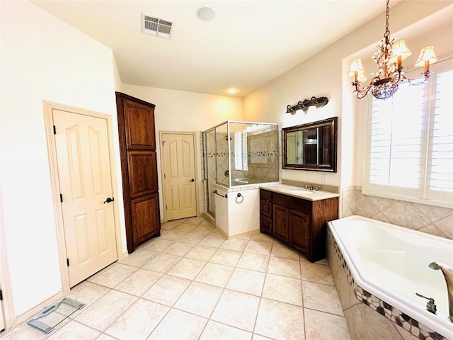 300 Copper Ln, Leander, TX 78641 - bathroom with a chandelier, a stall shower, a bath, vanity, and tile patterned floors