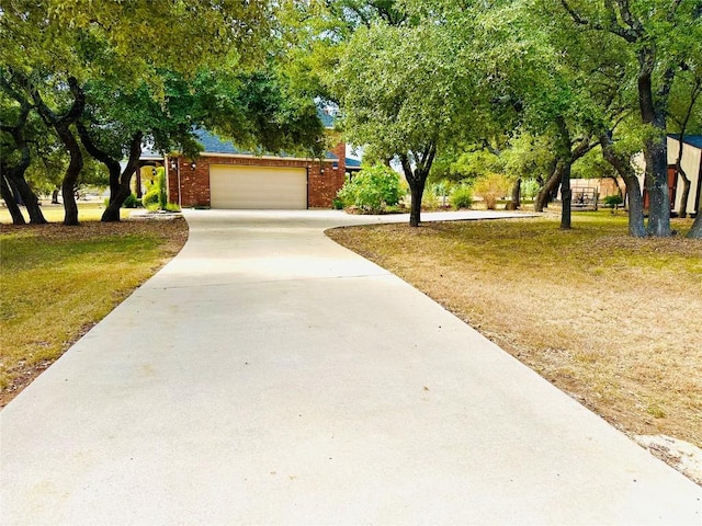 300 Copper Ln, Leander, TX 78641 - view of community featuring driveway, a lawn, and a garage