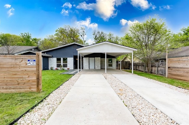 single story home with a carport and a front lawn