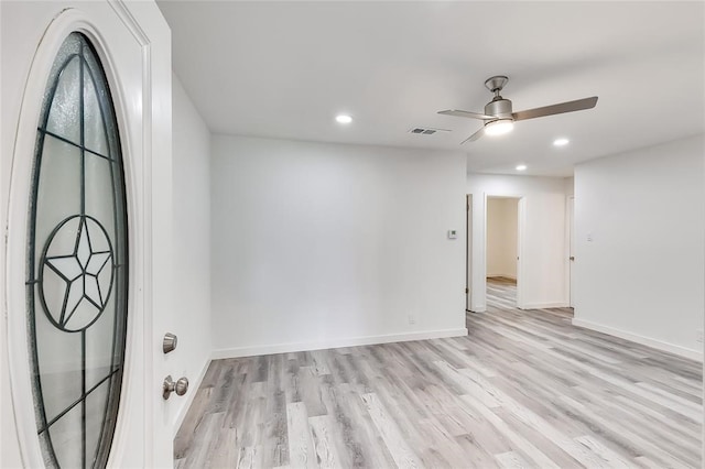 spare room featuring light hardwood / wood-style floors and ceiling fan