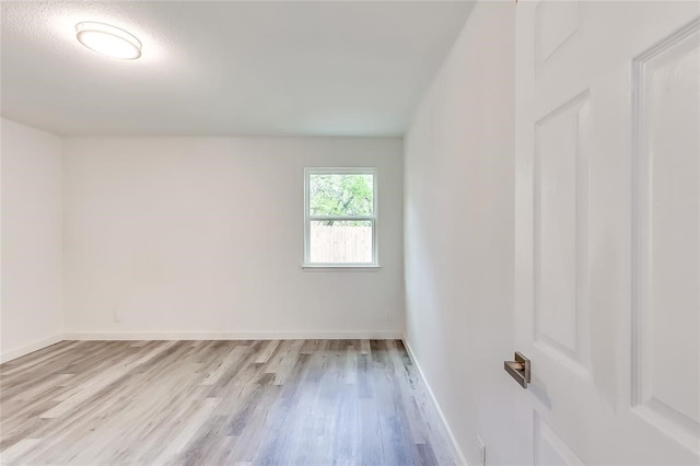 empty room with light hardwood / wood-style flooring