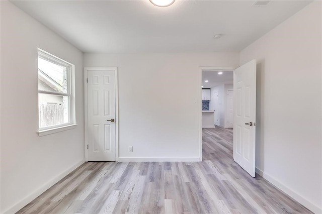 unfurnished room with light hardwood / wood-style floors