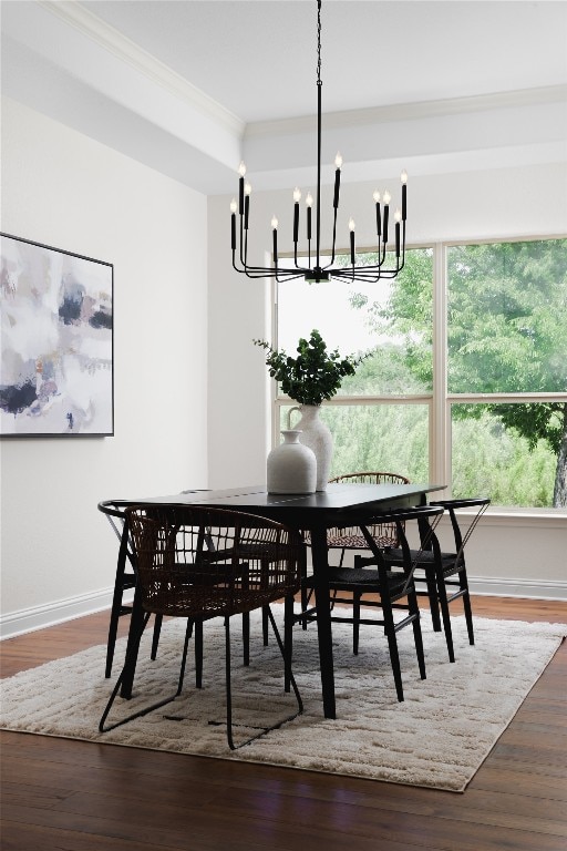 dining space with wood-type flooring and ornamental molding