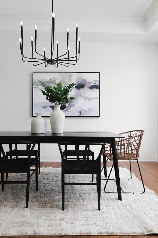 dining space featuring hardwood / wood-style flooring and a raised ceiling