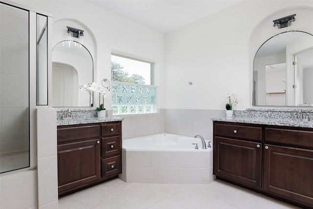 bathroom with vanity, independent shower and bath, and tile patterned floors