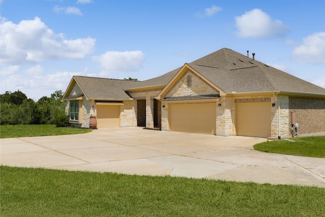 view of front of house with a front yard and a garage